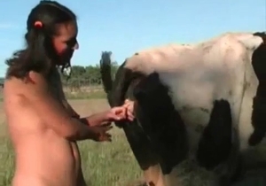 Pigtailed brunette blows a sexy beast